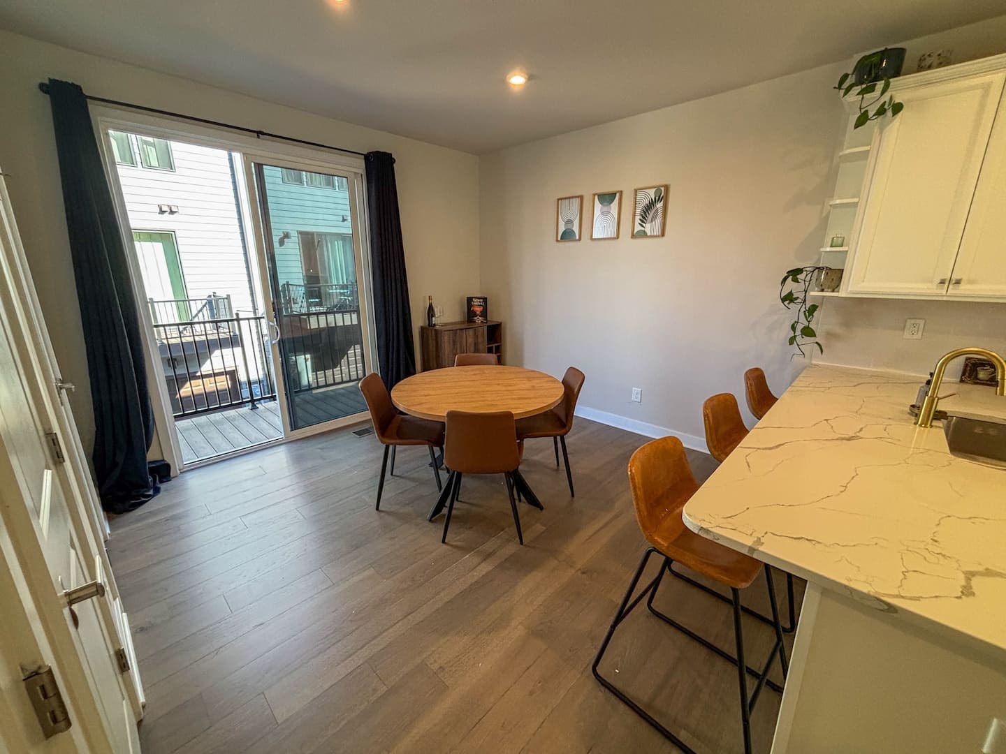 Dining area with table seating beside the balcony doors